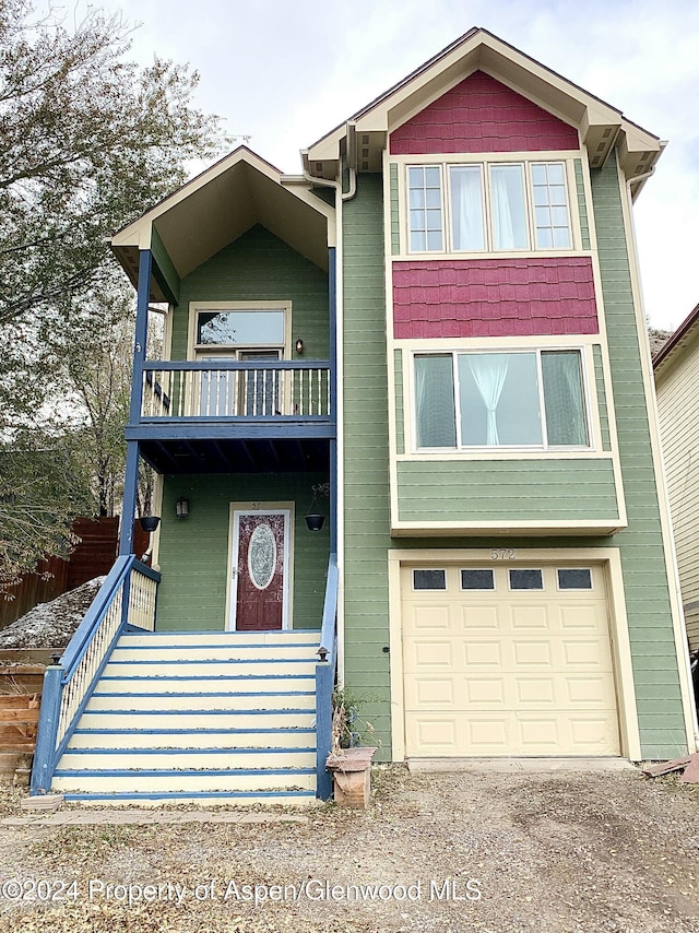 view of front facade with a balcony and a garage