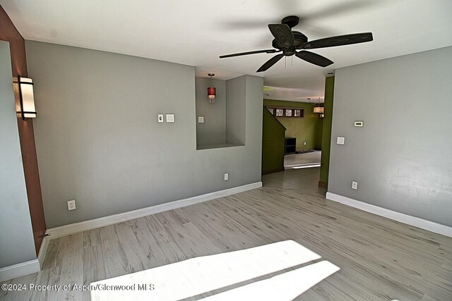 spare room with light wood-type flooring and ceiling fan