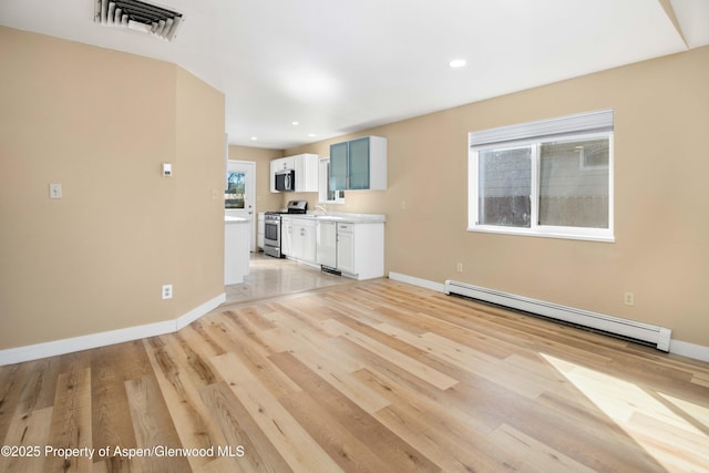 272 Birch Ct, Silt, CO 81652 - unfurnished living room with recessed lighting, a baseboard radiator, baseboards, and light wood-style flooring