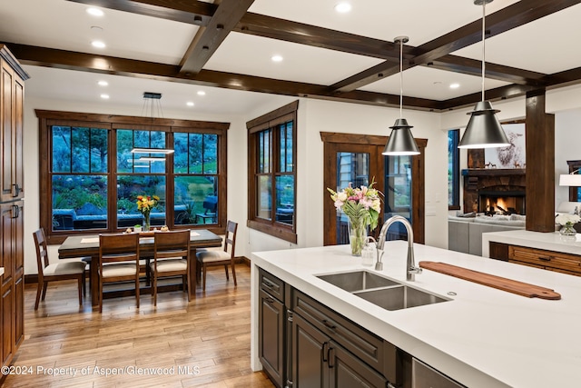 564 Larkspur Dr, Carbondale, CO 81623 - kitchen featuring a sink, light countertops, coffered ceiling, light wood-type flooring, and beam ceiling