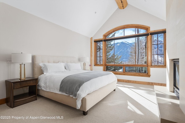 carpeted bedroom featuring lofted ceiling with beams