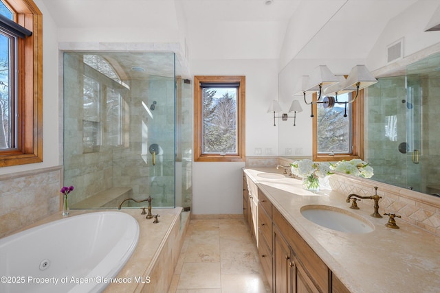 bathroom featuring lofted ceiling, vanity, tile patterned floors, and independent shower and bath