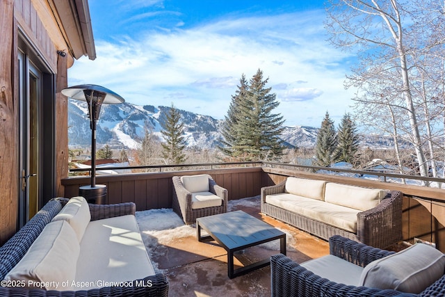 snow covered patio featuring outdoor lounge area and a mountain view