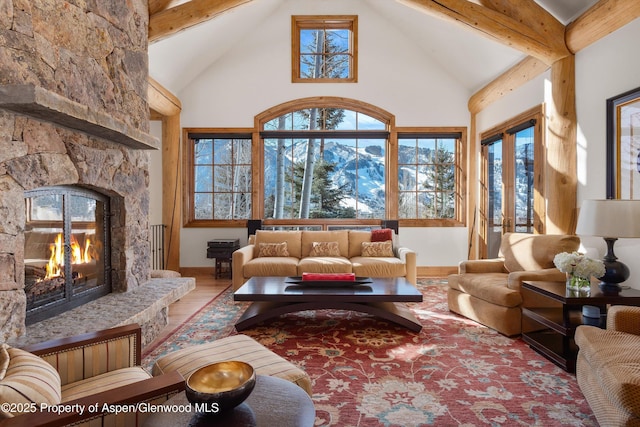 living room featuring hardwood / wood-style flooring, a fireplace, and lofted ceiling with beams