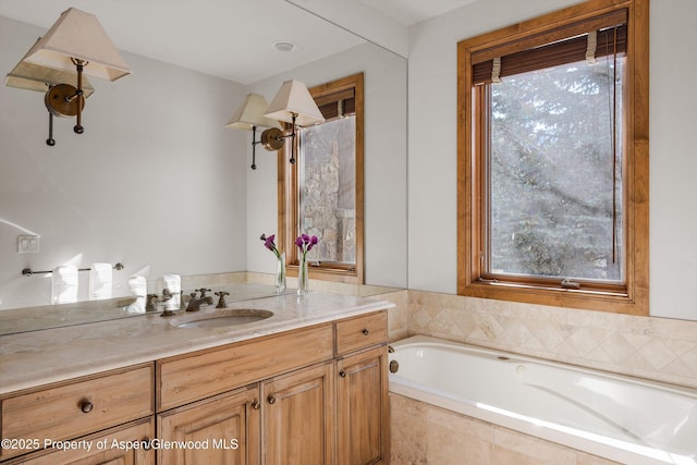 bathroom featuring vanity and tiled bath