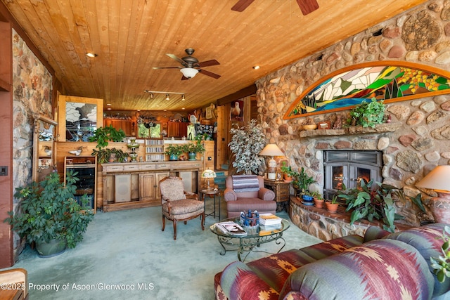 1789 Medicine Bow Rd, Aspen, CO 81611 - living room featuring a ceiling fan, wooden ceiling, carpet floors, and a stone fireplace