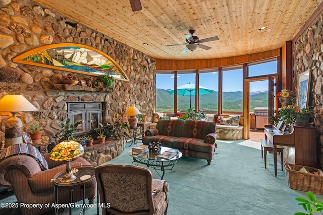 1789 Medicine Bow Rd, Aspen, CO 81611 - carpeted living area featuring wooden ceiling, a mountain view, ceiling fan, and a fireplace