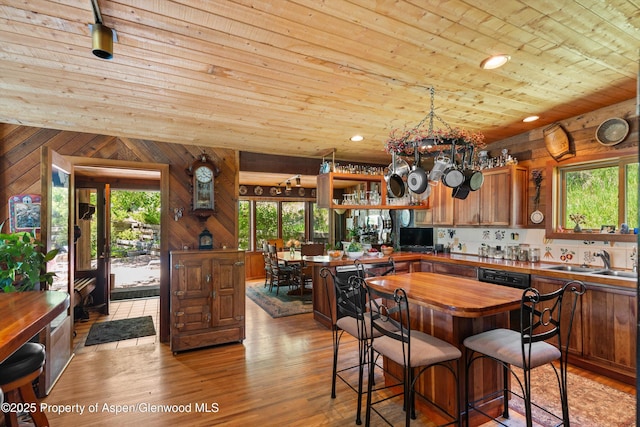 1789 Medicine Bow Rd, Aspen, CO 81611 - kitchen featuring wood counters, wooden ceiling, light wood-style flooring, wood walls, and a chandelier
