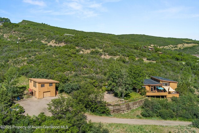 1789 Medicine Bow Rd, Aspen, CO 81611 - aerial view of property and surrounding area featuring a heavily wooded area and a mountain backdrop