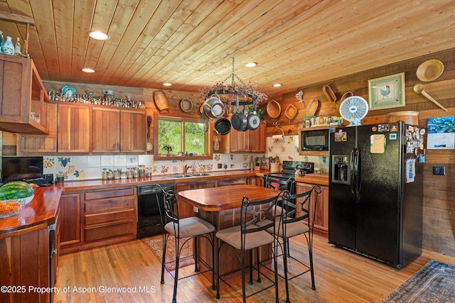 1789 Medicine Bow Rd, Aspen, CO 81611 - kitchen featuring black appliances, butcher block countertops, wood ceiling, light wood-type flooring, and recessed lighting