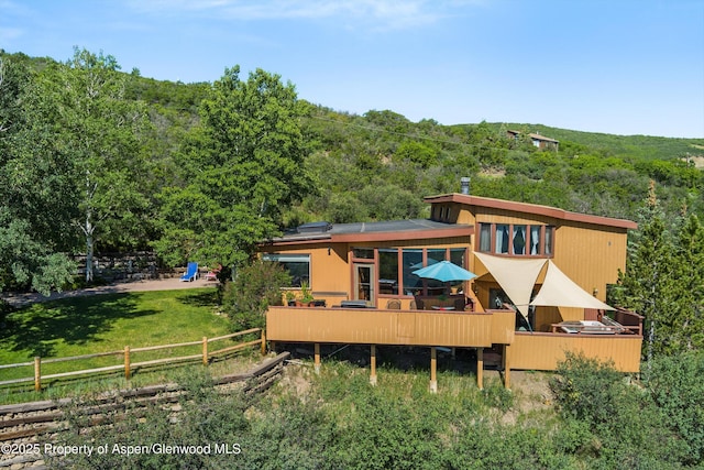 1789 Medicine Bow Rd, Aspen, CO 81611 - back of house featuring a forest view and a wooden deck