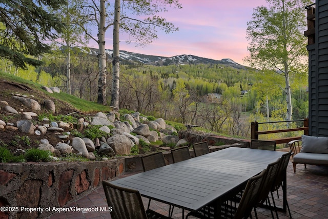172 Deer Ridge Ln, Snowmass Village, CO 81615 - view of patio / terrace featuring a mountain view, outdoor dining space, and a view of trees