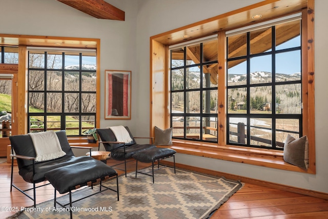 172 Deer Ridge Ln, Snowmass Village, CO 81615 - sitting room featuring a mountain view, wood-type flooring, baseboards, and lofted ceiling