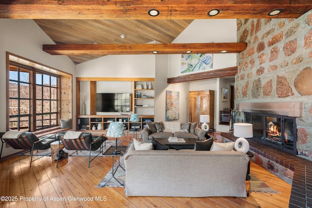 172 Deer Ridge Ln, Snowmass Village, CO 81615 - living area featuring a fireplace, hardwood / wood-style flooring, wood ceiling with exposed beams, and high vaulted ceiling