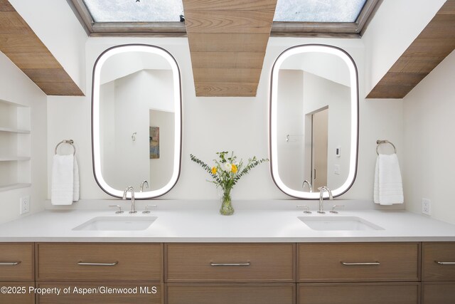 172 Deer Ridge Ln, Snowmass Village, CO 81615 - full bath with double vanity, built in shelves, and a skylight