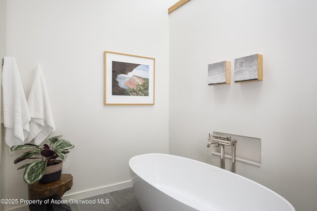 172 Deer Ridge Ln, Snowmass Village, CO 81615 - bathroom featuring a freestanding bath, tile patterned flooring, and baseboards