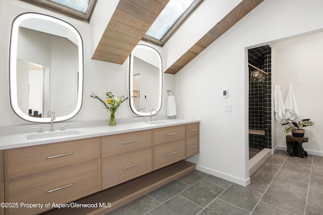 172 Deer Ridge Ln, Snowmass Village, CO 81615 - full bath featuring a skylight, double vanity, a tile shower, baseboards, and lofted ceiling