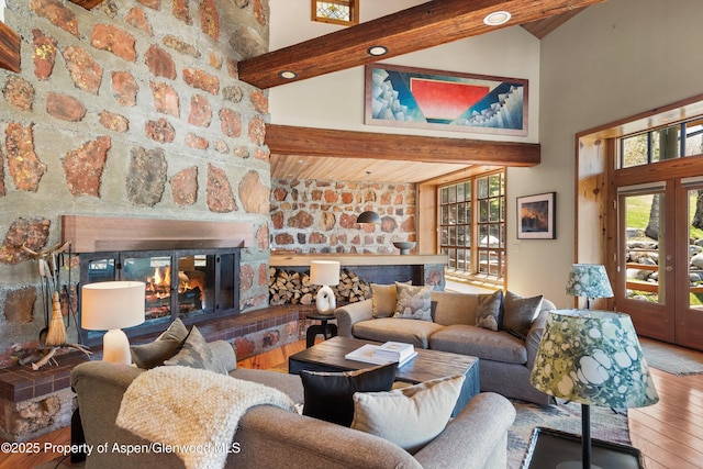 172 Deer Ridge Ln, Snowmass Village, CO 81615 - living area featuring high vaulted ceiling, french doors, a glass covered fireplace, wood-type flooring, and wood ceiling with exposed beams
