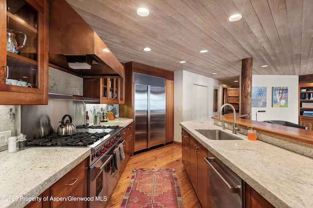 172 Deer Ridge Ln, Snowmass Village, CO 81615 - kitchen featuring high quality appliances, a sink, light wood-style floors, recessed lighting, and glass insert cabinets