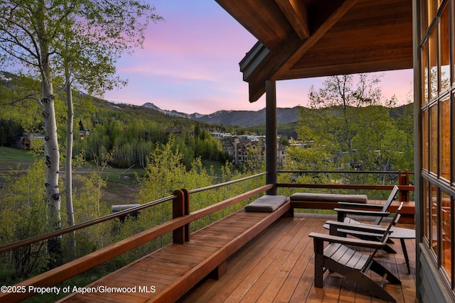 172 Deer Ridge Ln, Snowmass Village, CO 81615 - deck at dusk featuring a mountain view