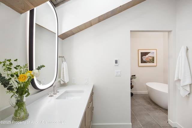 172 Deer Ridge Ln, Snowmass Village, CO 81615 - bathroom with vanity, a freestanding bath, baseboards, and tile patterned floors