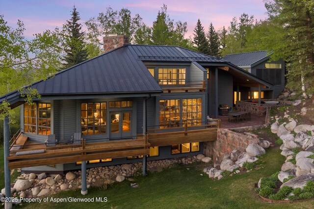 172 Deer Ridge Ln, Snowmass Village, CO 81615 - back of property featuring a standing seam roof, a chimney, metal roof, and a yard
