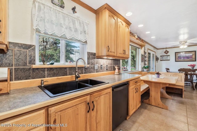 kitchen featuring plenty of natural light, a sink, dishwashing machine, and light tile patterned floors