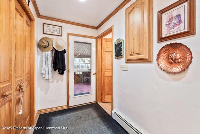 entryway with crown molding and dark colored carpet