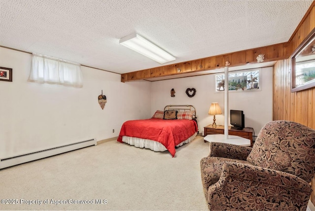 bedroom featuring a baseboard heating unit and carpet