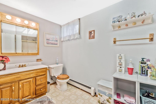 bathroom with baseboard heating, a shower, vanity, baseboards, and toilet