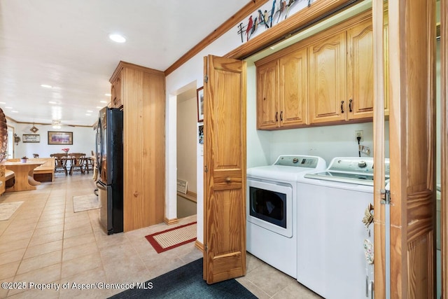 laundry room featuring ornamental molding, recessed lighting, washer and clothes dryer, cabinet space, and light tile patterned floors