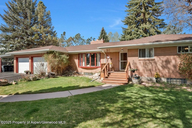 ranch-style house featuring an attached garage, aphalt driveway, brick siding, and a front yard