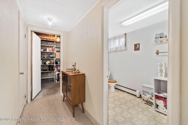 corridor with a baseboard heating unit