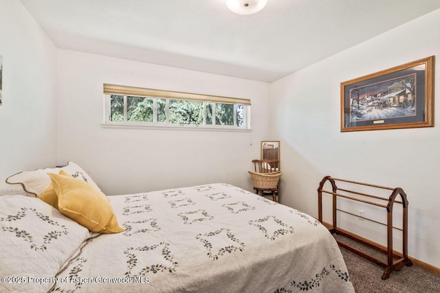 carpeted bedroom featuring baseboards