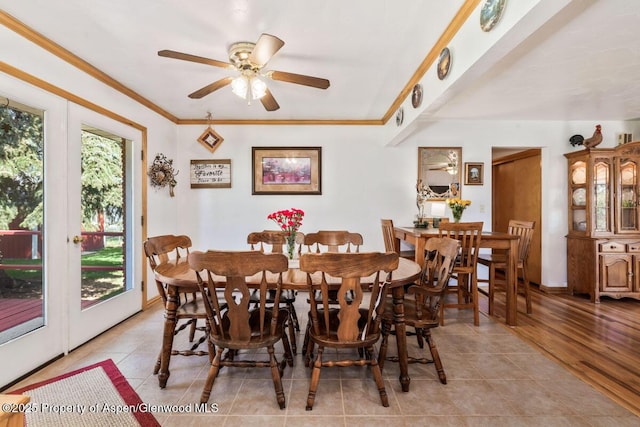 dining area featuring a ceiling fan, light tile patterned flooring, and ornamental molding