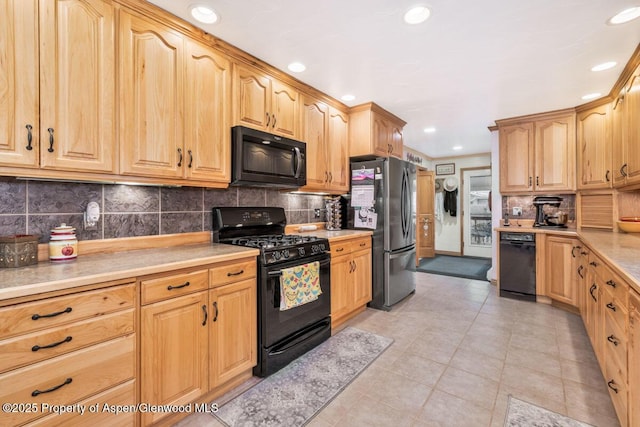 kitchen featuring recessed lighting, light countertops, tasteful backsplash, light tile patterned floors, and black appliances