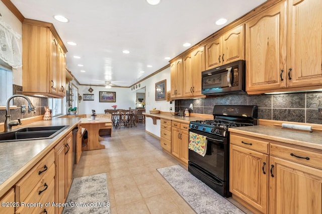 kitchen with recessed lighting, a sink, decorative backsplash, and gas stove