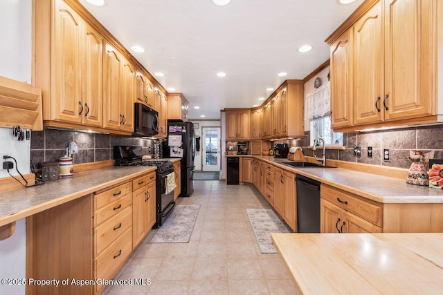 kitchen featuring recessed lighting, a sink, backsplash, and black appliances