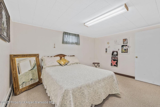 bedroom featuring a baseboard heating unit and light carpet