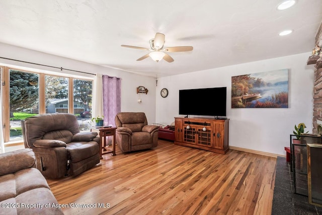 living room with recessed lighting, ceiling fan, baseboards, and light wood-style floors