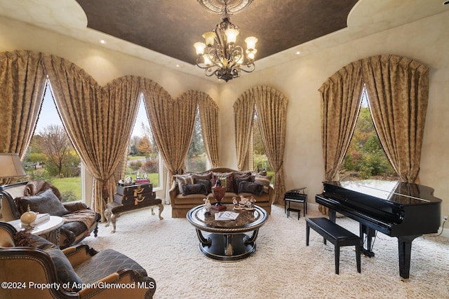 sitting room featuring carpet, a tray ceiling, and a notable chandelier