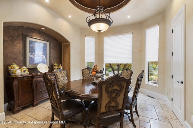 dining space featuring a raised ceiling