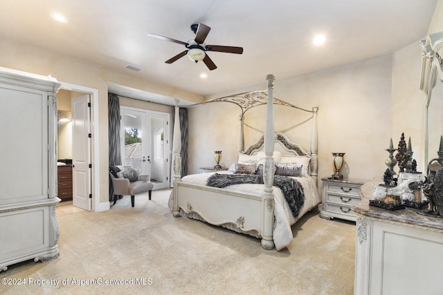 carpeted bedroom with ceiling fan, french doors, and ensuite bathroom