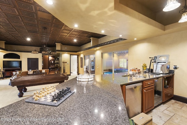 kitchen with stone counters, stainless steel dishwasher, and billiards