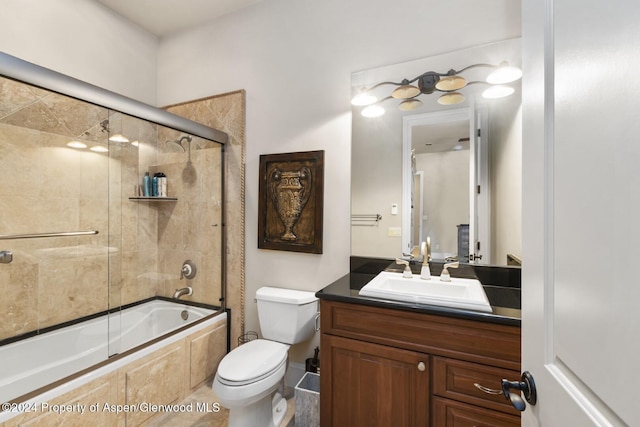 full bathroom with toilet, vanity, and combined bath / shower with glass door