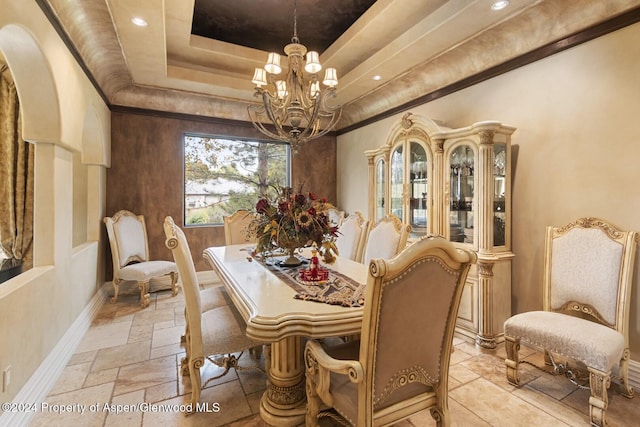 dining room with a tray ceiling and an inviting chandelier