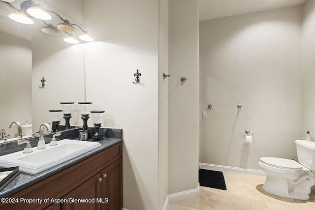 bathroom featuring tile patterned floors, vanity, and toilet