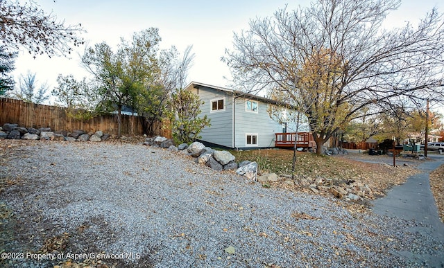 view of side of home with a wooden deck