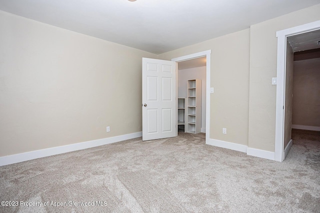 unfurnished bedroom featuring light colored carpet
