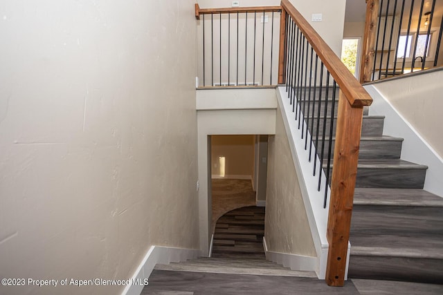 stairway with hardwood / wood-style flooring